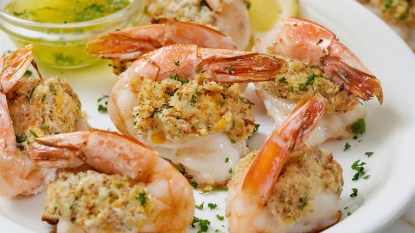 Crab stuffed shrimp served on a platter with melted butter and lemon wedges