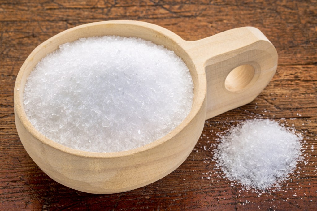 Epsom salt in wooden bowl on table