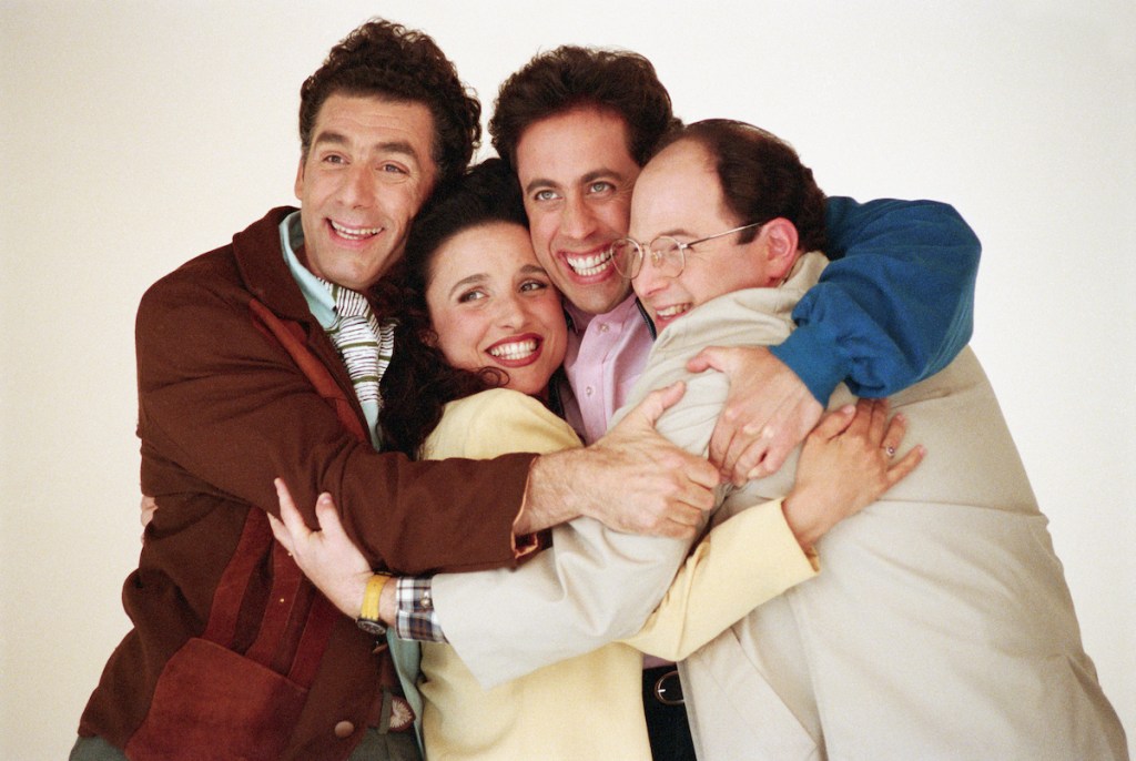 Michael Richards, Julia Louis-Dreyfus, Jerry Seinfeld and Jason Alexander embracing in 1993