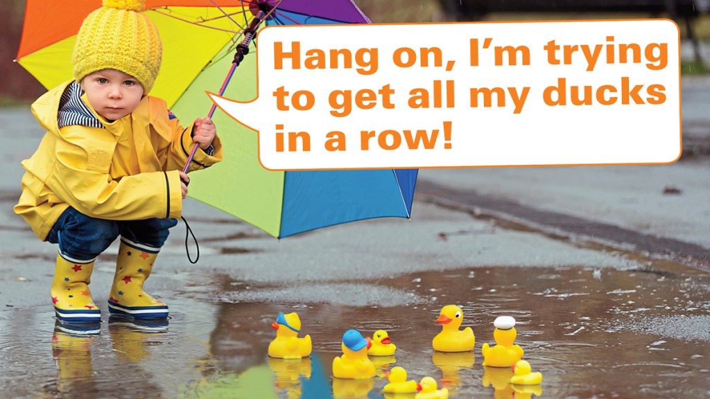 Funny photos: Boy with rubber ducks in puddle and caption, "Hang on, I'm trying to get all my ducks in a row."