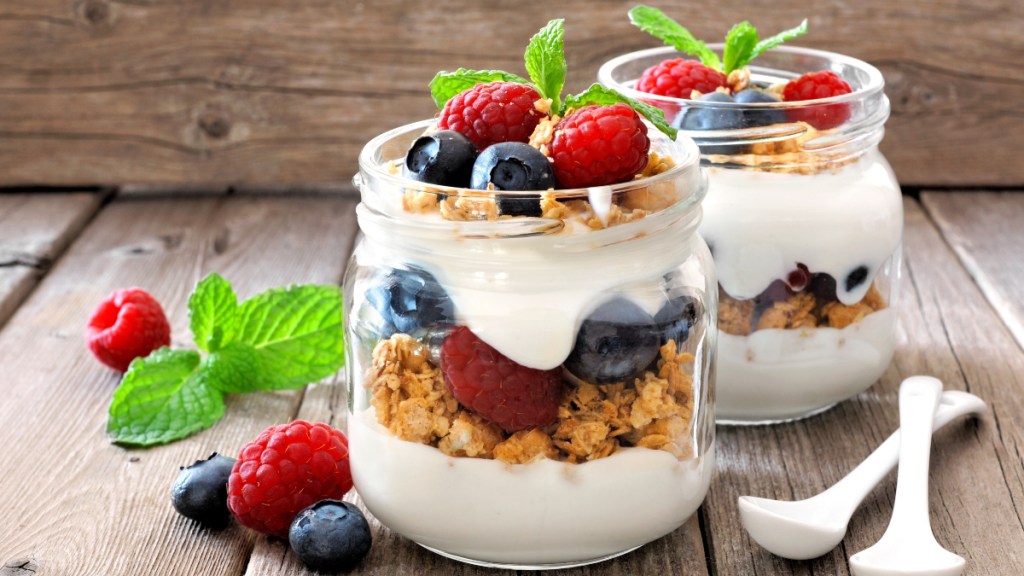 A yogurt parfait layered with granola and fresh berries, which contain vitamins that help stop age-related muscle loss