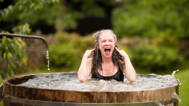 Woman in cold plunge tub outside—cold plunge menopause