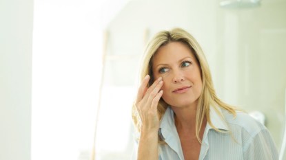 woman applying vaseline under watery eyes