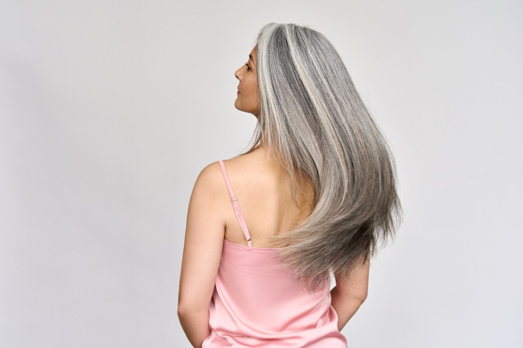 back of mature woman with grey hair after doing keratin treatment
