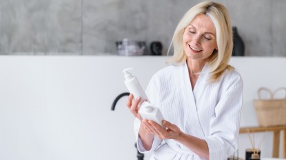 mature woman looking at different hair care brands