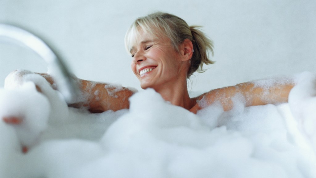 A blonde woman in a bubble bath