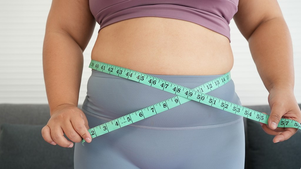 woman measuring her belly with tape measure; Atlantic diet