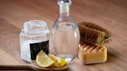 overnight cleaning hacks: vinegar, lemon juice and baking soda on wooden countertop