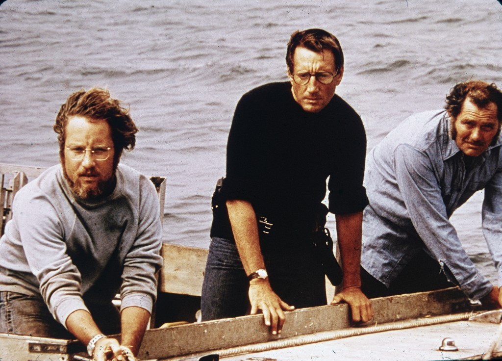 Richard Dreyfuss, Roy Scheider and Robert Shaw on board a boat in a still from the film, 'Jaws,'1975