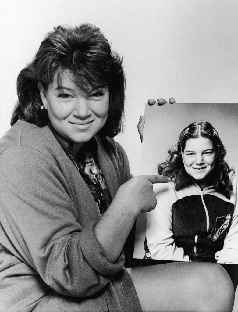 Mindy Cohn in 1985 holding a picture of herself from 1979