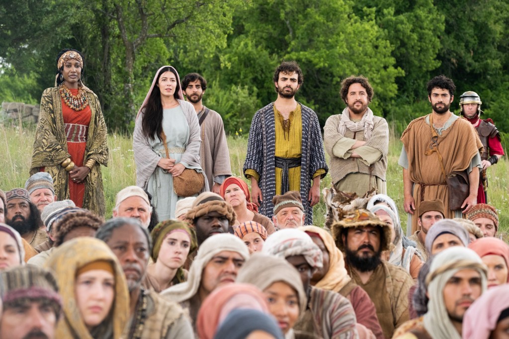 Elizabeth Tabish as Mary Magdalene—along with the Disciples and a crowd—listening and learning from Jesus in Season 3 of The Chosen
