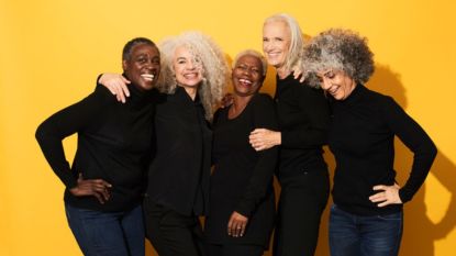 group of mature women against yellow background celebrating wellness